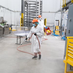A team member cleans the floor 