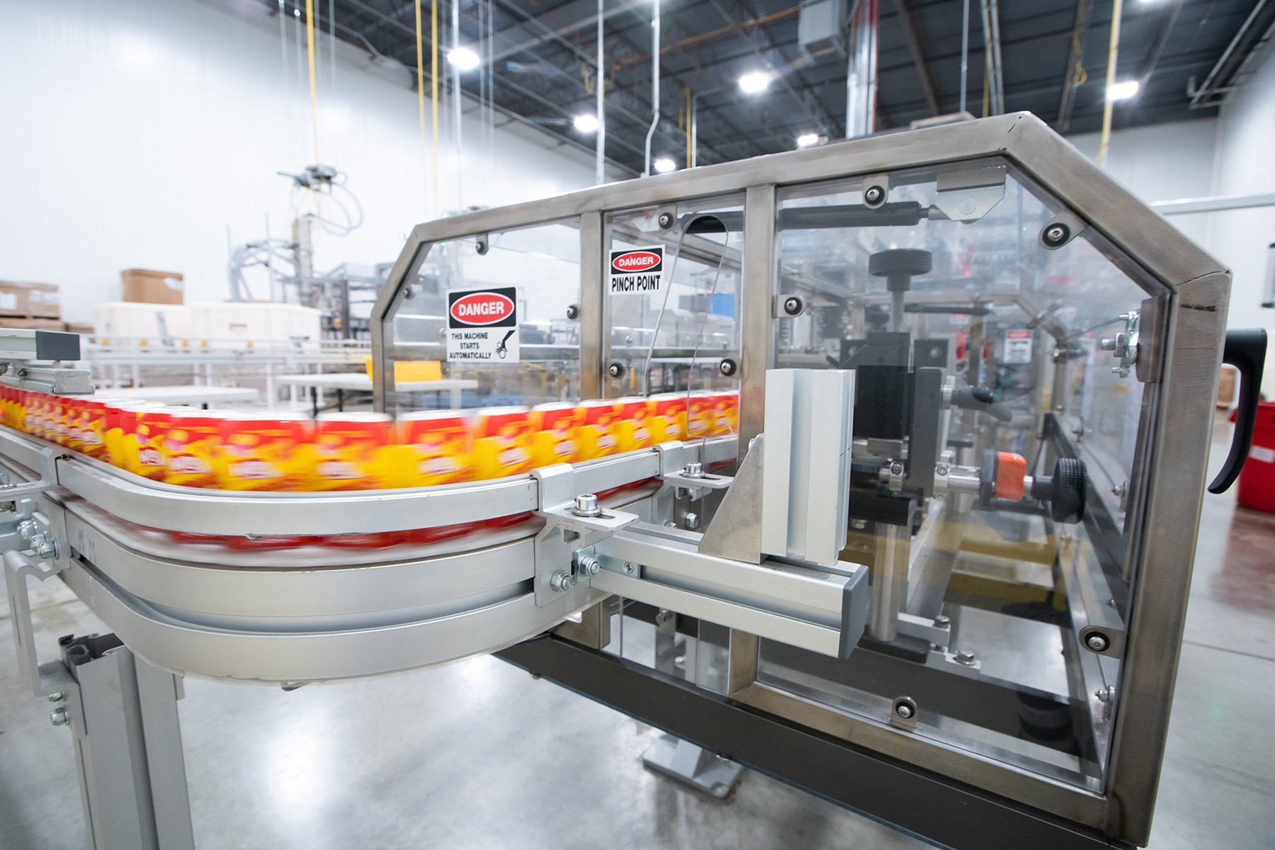 plastic gum containers race down a conveyor belt plastic gum containers race down a conveyor belt