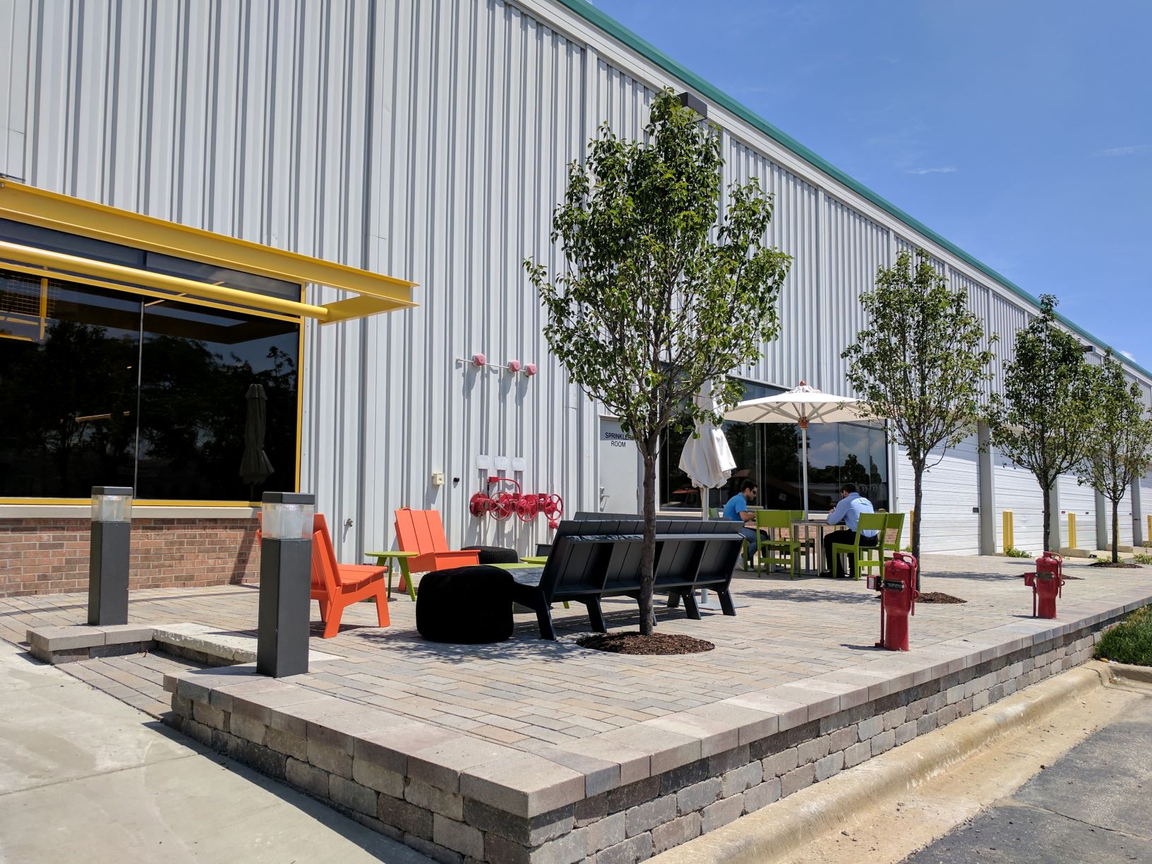 creative werks employees sit outside for lunch at the headquarters in Elk Grove Village